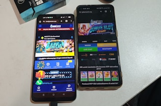 Two smartphones are displayed on a white surface, both showing gambling websites with colorful graphics, text, and various options for logging in and accessing games. The screens are bright and filled with promotional content related to casino and slot games.